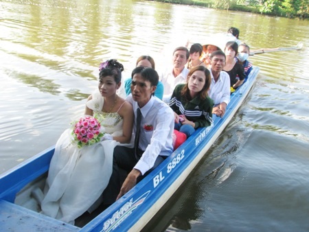 Thú vị cảnh rước dâu ở vùng sông nước miền Tây - 20 Chiếc vỏ lãi thường rất chông chênh nên chú rể phải rất cẩn thận dìu cô dâu xuống để không bị ngã.