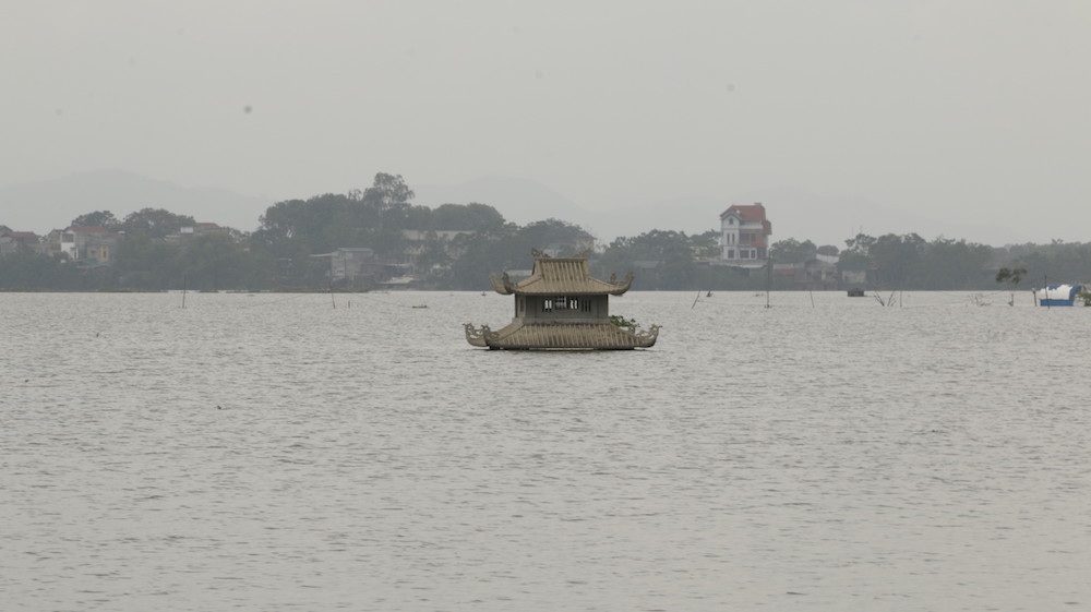 
Một ngôi mộ chỉ còn phần mái nhô lên trên mặt nước.
