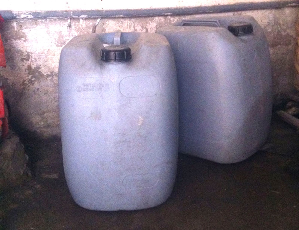 Những can nhựa đựng a xít để làm dấm. (Ảnh: Hiến Chương)