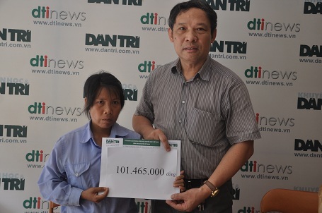 Ông Phạm Huy Thân - Cháng văn phòng báo điện tử Dân trí trao quà của bạn đọc đến chị Kim.