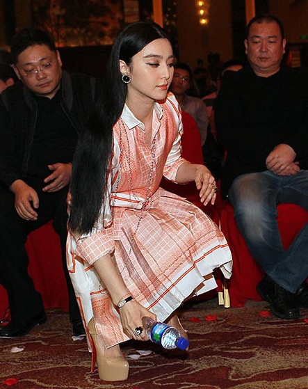 Người đẹp bất ngờ cúi xuống nhặt một vỏ chai đã uống cạn khi phát hiện nó nằm trên thảm đỏ.