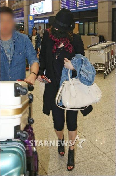 Cô thậm chí còn lấy ví cầm tay che lên mặt để tránh ánh mắt và ống kính của giới săn tin.