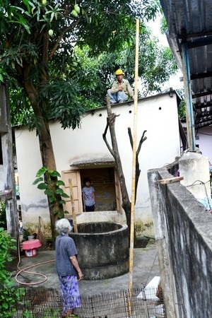 Cháu nhỏ "hút chết" vì thanh sắt rơi từ bệnh viện đang xây - 1 Hai thanh đà bằng sắt rơi xuống vườn nhà bà Cúc, một thanh cắm thẳng xuống giếng