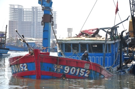 Các thợ lặn đang tiến hành cột dây để kéo tàu cá lên