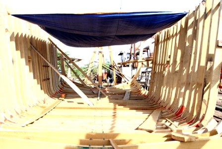 Anh Trần Văn Vốn bên cạnh con tàu đang đóng mới