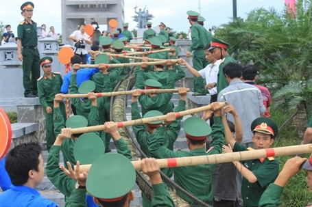 Các chiến sĩ bộ đội đưa bánh vào đài chính để dâng lên các liệt sĩ