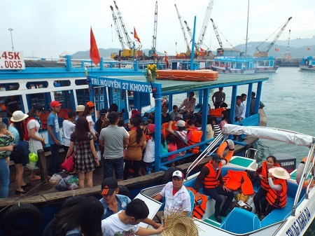 Du khách lên tàu, mặc áo phao tham quan các đảo trên Vịnh Nha Trang, sáng mùng 3 Tết Ất Mùi.