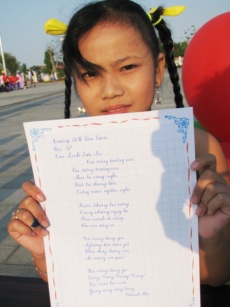 Học sinh sôi nổi thi viết chữ đẹp nhân ngày Thơ Việt Nam - 6 Một em học sinh khoe tác phẩm của mình.