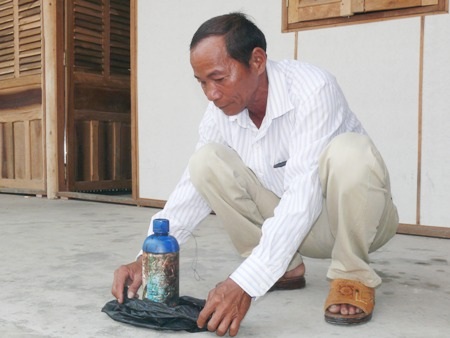 Ông Trà với chai thuốc đã gây ra tai nạn cho con trai.