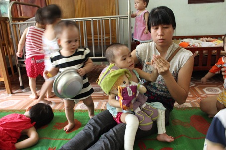 Trào nước mắt gặp lại em bé "có giòi" ở chùa Bồ Đề - 5 Chị Kim Dung đang xem những vết thương ở chân và tay Tâm Anh