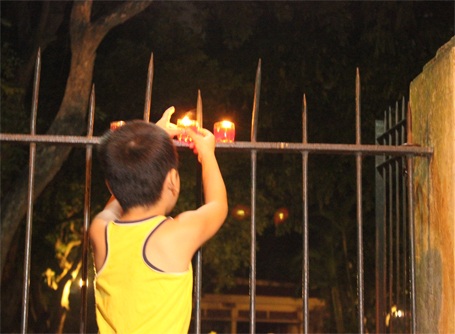 Nhà riêng Đại tướng sáng rực nến tưởng nhớ Người - 9 Một em nhỏ thắp nến trước nhà Đại tướng