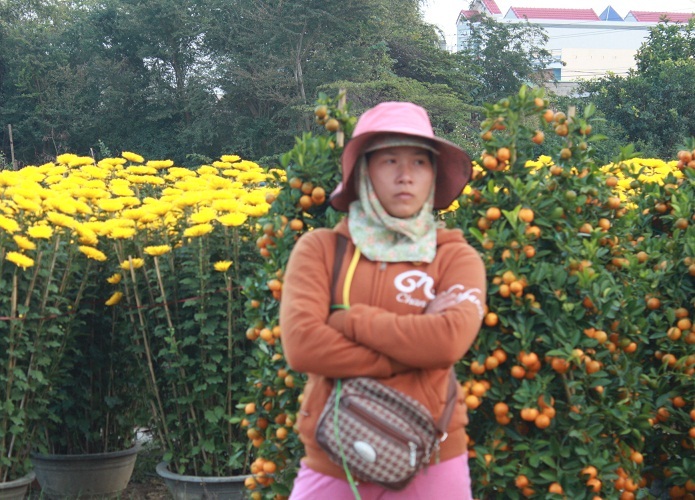 Khuôn mặt buồn rầu hiện rõ trên khuôn mặt người bán hoa Tết