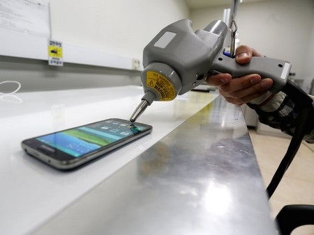 Cận cảnh quá trình kiểm tra độ bền của Galaxy S5 trước khi xuất xưởng - 8 Các kỹ sư sử dụng một cây súng bắn tĩnh điện để kiểm tra khả năng chống sốc điện từ Galaxy S5.