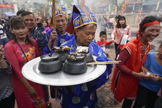 Sôi động trong khói lửa hội thổi cơm thi Thị Cấm - 13 Trong vòng 30 phút, 4 nồi cơm của 4 đội đã chín và được các cụ rước vào đình làng chấm điểm.