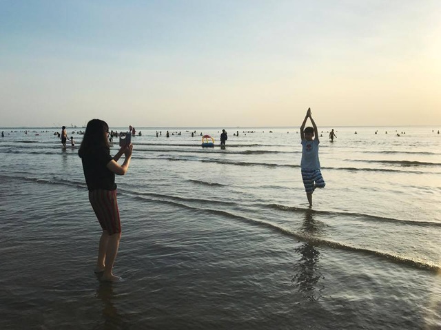 Phó nháy trải lòng khi bị smartphone lấy đi "miếng cơm, manh áo" - 1 Một cậu nhóc đang tạo dáng trên bãi biển để người thân chụp lại bằng smartphone.