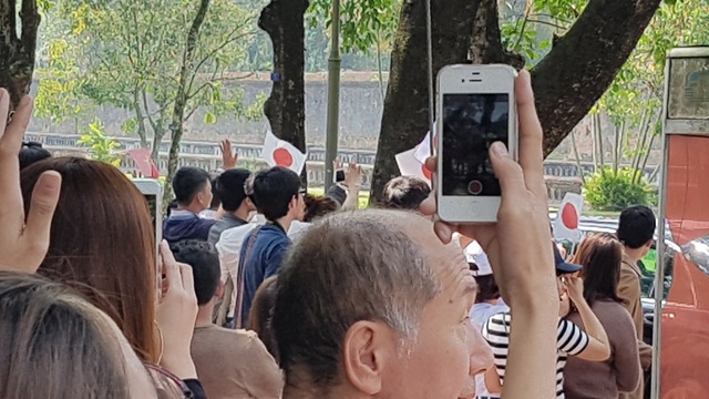 Du khách và người dân Huế háo hức đón Nhật hoàng vào thăm Hoàng Cung Huế - 15 Đáp lại là nhiều tiếng reo mừng, chúc mừng bằng tiếng Việt và tiếng Nhật, kèm theo rừng máy điện thoại ghi lại khoảnh khắc Nhà và và Hoàng hậu lên xe