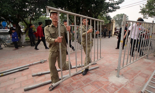 Người dân Ném Thượng tiếp tục chém lợn trong nhà kín - 7
Trong lúc đoàn rước đi quanh làng, ban tổ chức cũng gấp rút chuẩn bị hàng rào để ngăn người dân tiếp cận khu vực làm cỗ ngọc tế thánh.