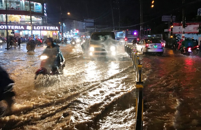 Khốn đốn lội nước cạnh hồ điều tiết chống ngập thông minh - 4 Xe cộ bì bõm lội qua khu vực ngập nước gần Nhà Thiếu nhi Thủ Đức.