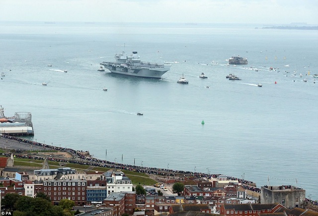 Siêu tàu sân bay Anh lần đầu cập cảng sau 6 tuần thử nghiệm - 1 Tàu sân bay HMS Queen Elizabeth của Hải quân Anh chở theo 700 nhân viên và khoảng 200 nhà thầu đã di chuyển về cảng Portsmouth lần đầu tiên vào sáng nay 16/8 trong sự chào đón nồng nhiệt của hàng nghìn người dân, trong đó có cả các thành viên trong gia đình thủy thủ đoàn trên tàu. (Ảnh: PA)