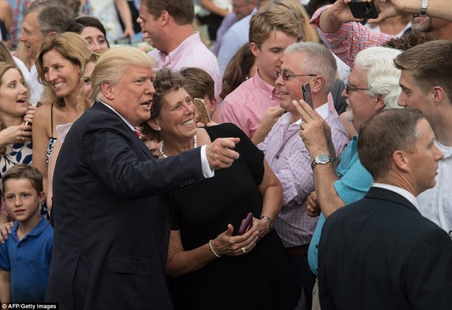 Gia đình ông Trump chơi hết mình trong bữa tiệc ngoài trời tại Nhà Trắng - 3 Nhân sự kiện có sự tham dự của nhiều nghị sĩ đến từ hai đảng Dân chủ và Cộng hòa, Tổng thống Trump đã kêu gọi sự đoàn kết và thống nhất. Ông nói: “Chúng tôi hy vọng rằng sự đoàn kết sẽ tiếp tục được tăng cường và phát triển giữa các nghị sĩ của hai đảng Dân chủ và Cộng hòa”. Trong ảnh: Tổng thống Trump chụp ảnh cùng các vị khách dự bữa tiệc ngoài trời. (Ảnh: AFP)