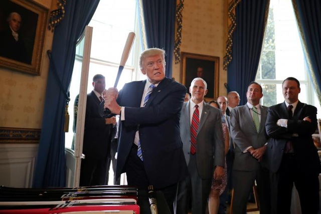 Tổng thống Trump đích thân quảng cáo hàng hóa của Mỹ - 2 Khi tới dự buổi triển lãm, nhà lãnh đạo Mỹ đã kêu gọi người dân ưu tiên sử dụng hàng hóa gắn mác “Made in America” và đích thân quảng cáo cho một số sản phẩm. Trong ảnh: Tổng thống Trump cầm cây gậy bóng chày, một sản phẩm được trưng bày tại buổi triển lãm, trước sự chứng kiến của các quan chức Nhà Trắng và lãnh đạo các doanh nghiệp.