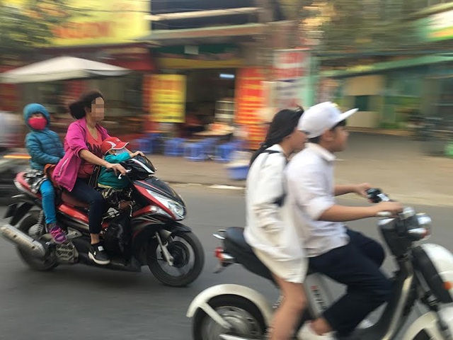 Vi phạm giao thông, học sinh rút tiền... mãi lộ CSGT! - 2 Nhiều phụ huynh đưa đón con em đi học nhưng cũng phớt mũ bảo hiểm