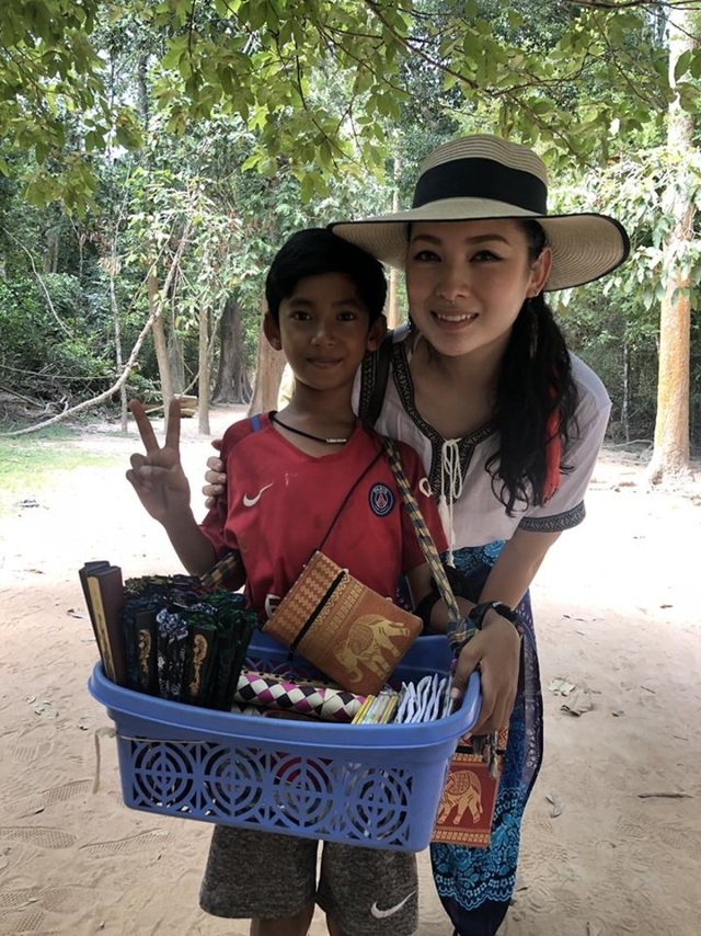 Cậu bé bán hàng rong gây sốt khi có thể nói tốt 15 thứ tiếng - 1 Cậu bé bán hàng rong người Campuchia chụp ảnh cùng khách du lịch