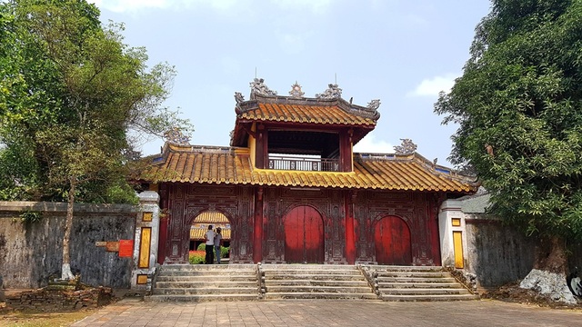 Bí ẩn về lăng mộ của vị vua Nguyễn - 7 Cổng tam quan làm bằng gỗ vào điện Minh Thành vẫn còn y nguyên theo dấu thời gian. Khu lăng mộ vua được tiến hành trong 6 năm (1814-1820) từ khi vợ chính của ngài qua đời vào 1814. Đích thân vua Gia Long đã thám sát, duyệt định vị trí, quy hoạch và chỉ đạo công tác thiết kế cũng như giám sát tiến độ thi công. Toàn bộ khu lăng mộ này có chu vi hơn 11.200m