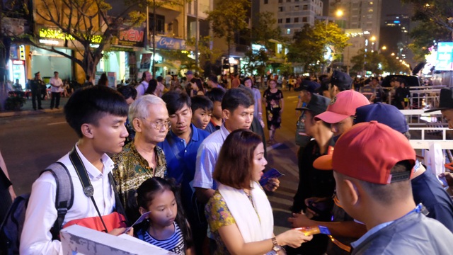 Náo nức xuống phố sớm “xí chỗ" xem pháo hoa - 6 Khán giả xếp hàng qua cửa soát vé vào khu vực khán đài xem pháo hoa trên đường Trần Hưng Đạo