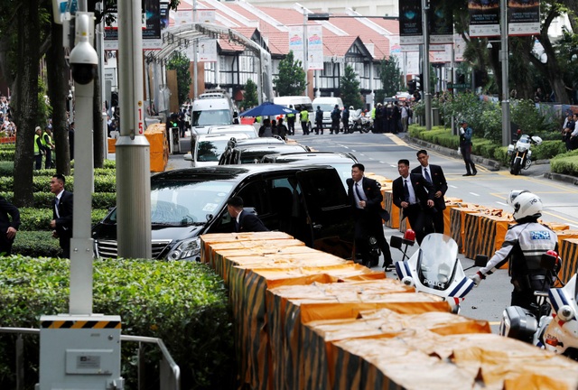 12 vệ sĩ chạy bộ tháp tùng ông Kim Jong-un về khách sạn tại Singapore - 4 12 vệ sĩ được nhìn thấy chạy theo xe chở ông Kim Jong-un khi xe này tiến vào khách sạn St Regis. (Ảnh: Reuters)