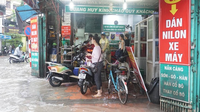 Mưa lớn dai dẳng, Hà Nội mênh mông nước ngập - 14
Cửa hàng sửa xe hốt bạc nhờ sửa xe chết máy. (Ảnh: Nguyễn Dương)