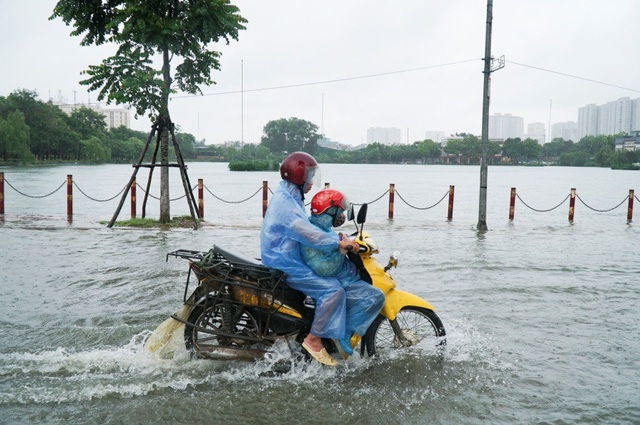 Hà Nội: Xe chết máy, nhà mặt phố phải chắn cửa vì nước ngập - 2
Nước dâng cao khiến người dân không thể phân biệt được giữa mặt đường và mặt hồ Văn Quán nếu như không có hàng cọc bên đường.