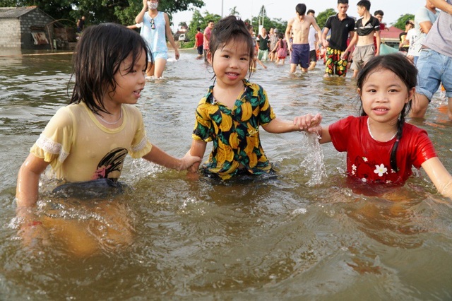 Hà Nội: Trẻ em thỏa thích bơi lội trên... tỉnh lộ - 4
Nước ngập trên diện rộng cũng khiến nhiều em nhỏ phải nghỉ học.