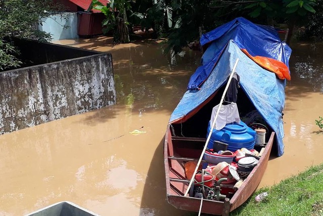 Nước ngập nhà, người dân phải di chuyển một số đồ đạc lên ở trên thuyền