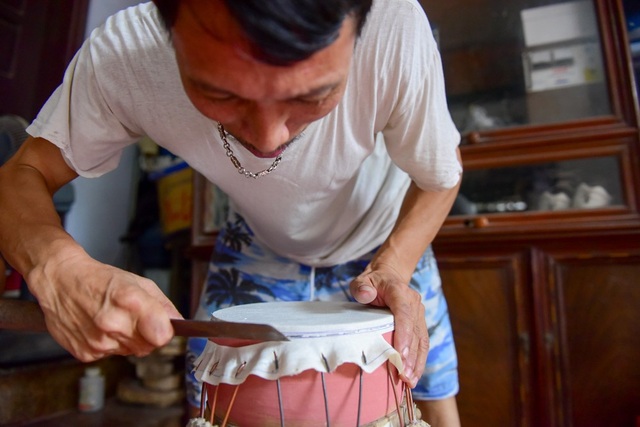 Làng làm trống đồ chơi tất bật vào mùa Trung thu - 9
Sau khi ghim, ông May dùng dao sắc cắt phần da thừa, hoàn thiện mặt trống.