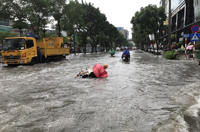 Đường phố Hà Nội thành sông, người dân “be bờ” ngăn nước vào nhà - 4 Đường phố Hà Nội thành sông, người dân “be bờ” ngăn nước vào nhà - 4