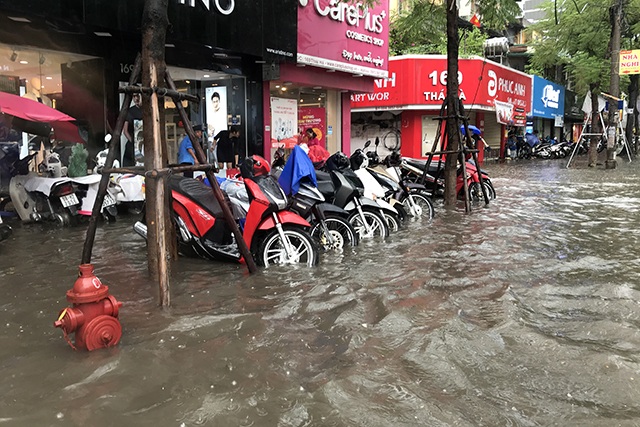 Đường phố Hà Nội thành sông, người dân “be bờ” ngăn nước vào nhà - 11 Đường phố Hà Nội thành sông, người dân “be bờ” ngăn nước vào nhà - 11