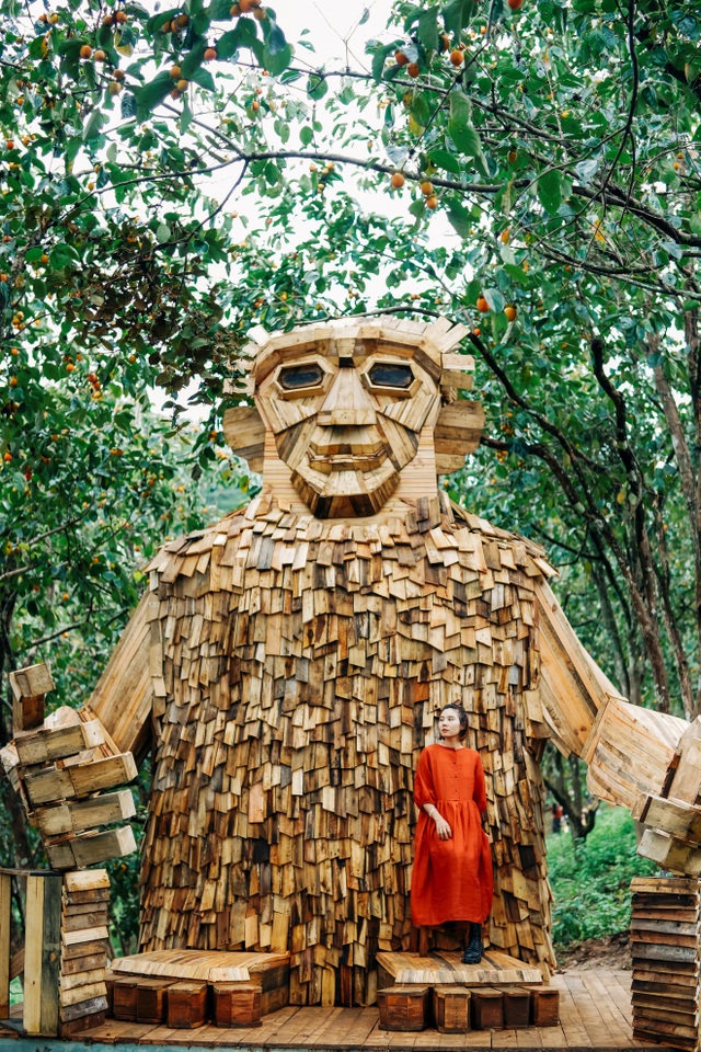 Tourists enjoy checking-in with a giant monster wooden statue in Da Lat - 1