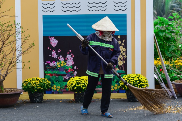 Tourists wearing ao dai check-in on the spring flower street in the rich street - 13