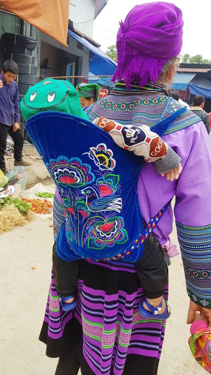 Children carried by mothers at Bac Ha Market - 9