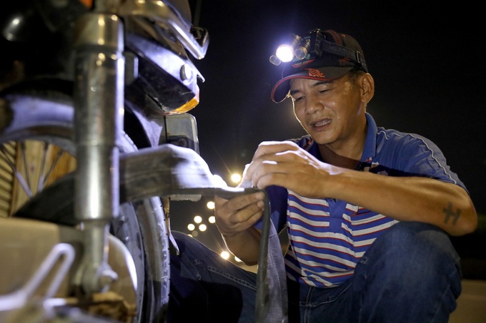 HCM City man offers free nighttime motorbike repair service - 1