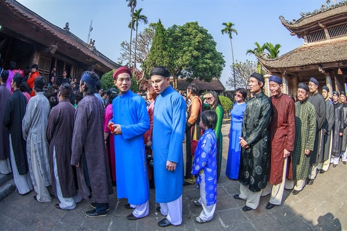 Artists, ambassadors bringing back áo dài for men - 1