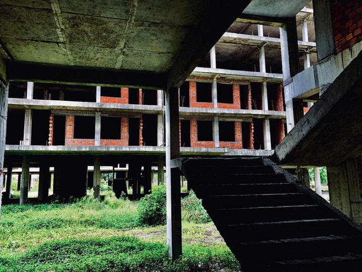 Nhiều khối nhà đang xây dở thì bỏ hoang, phủ rêu mốc