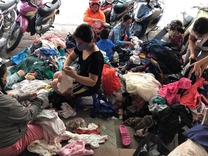 Không còn chỗ, chị Trang phải mở kiện ngay trên vỉa hè. (Ảnh: H.T.)