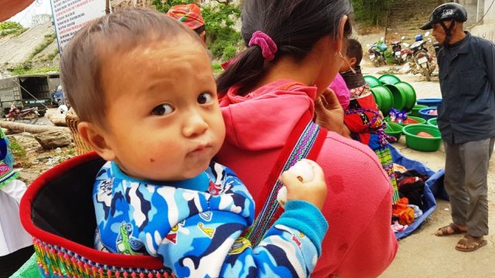 Children carried by mothers at Bac Ha Market - 4
