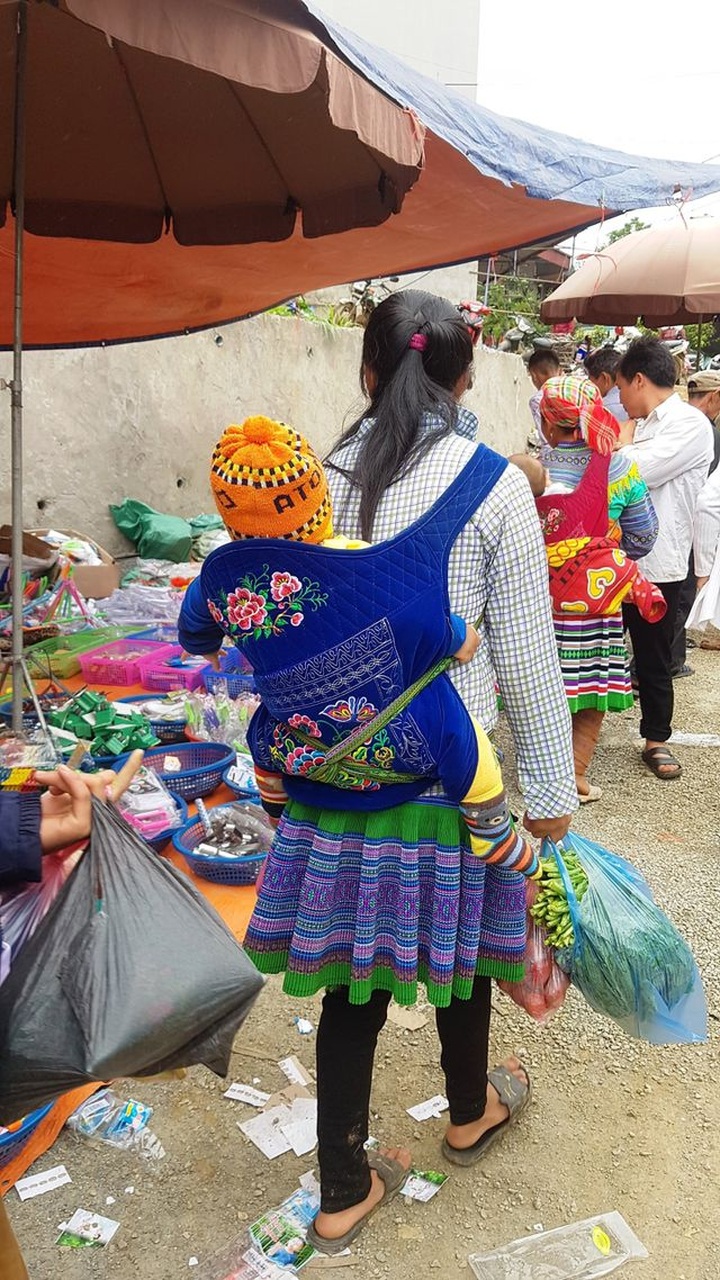 Children carried by mothers at Bac Ha Market - 3