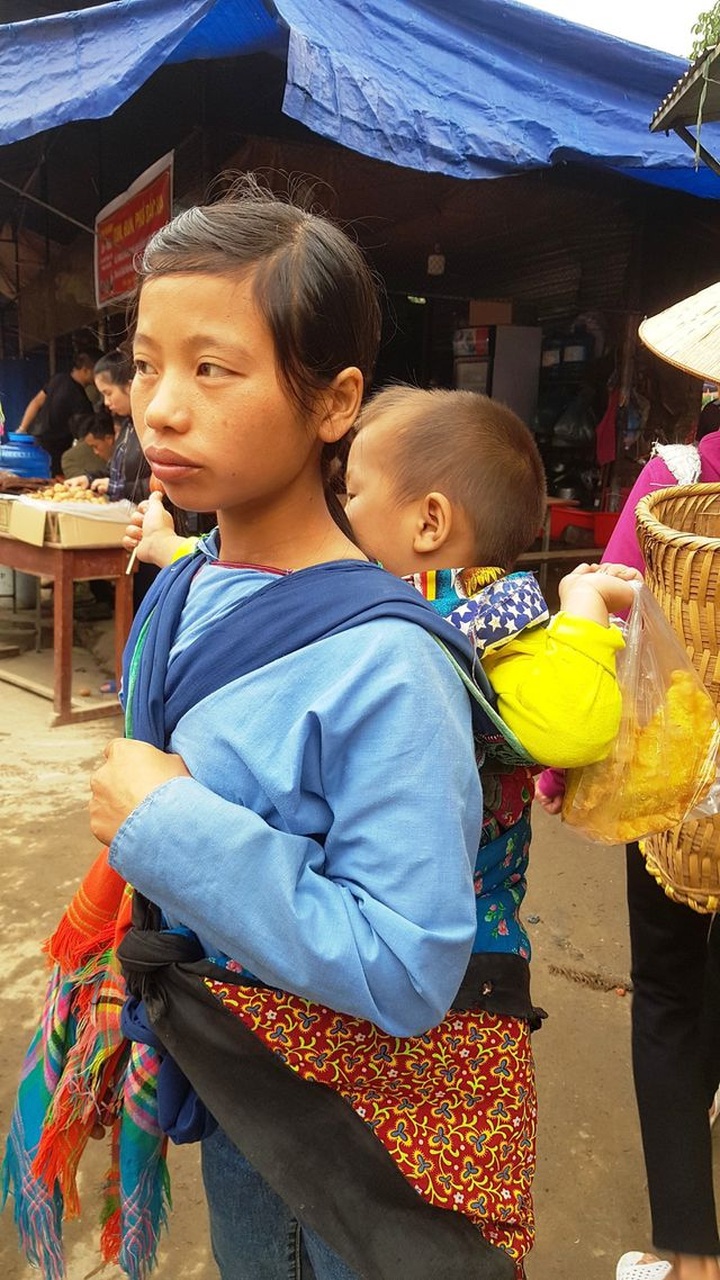Children carried by mothers at Bac Ha Market - 6