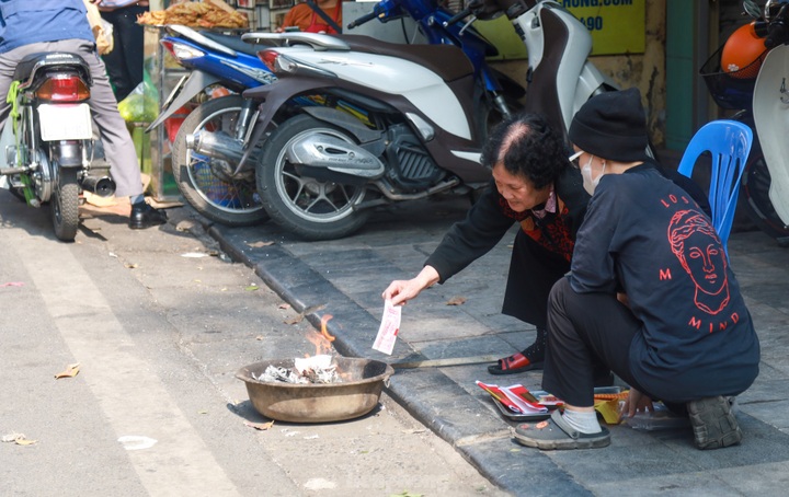 Votive paper burnt on Hanoi streets on Kitchen Gods’ Day - 3