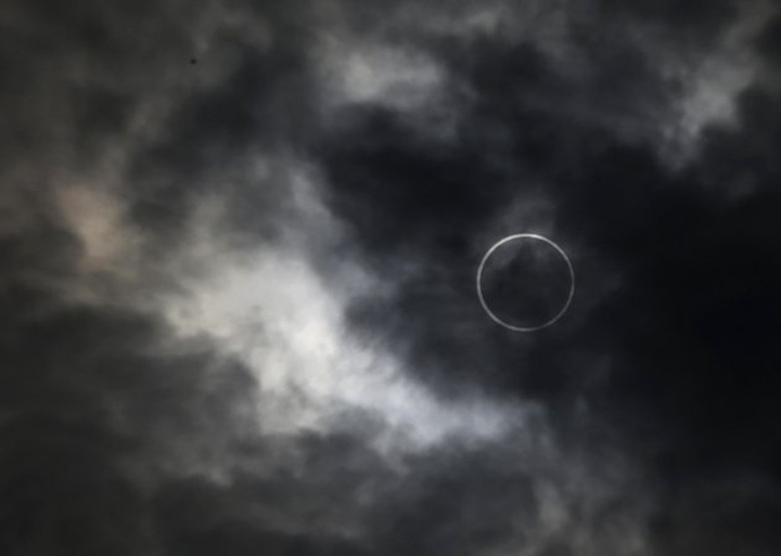 Millions look skyward as rare eclipse crosses Asia - 1