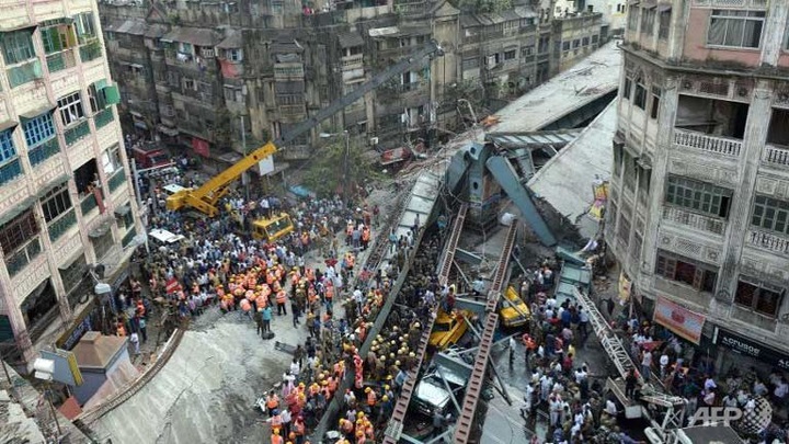 Indian workers battle to rescue victims trapped under collapsed flyover - 1